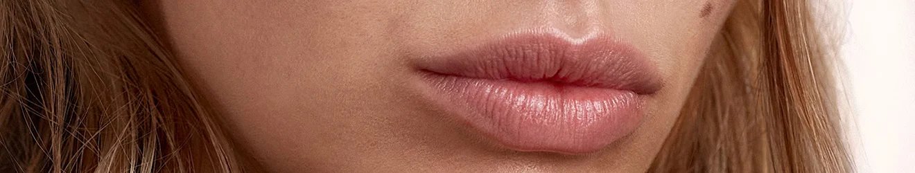 Maybelline Lip Balm products illustrative banner image - Close up of a woman's lips wearing lip balm 